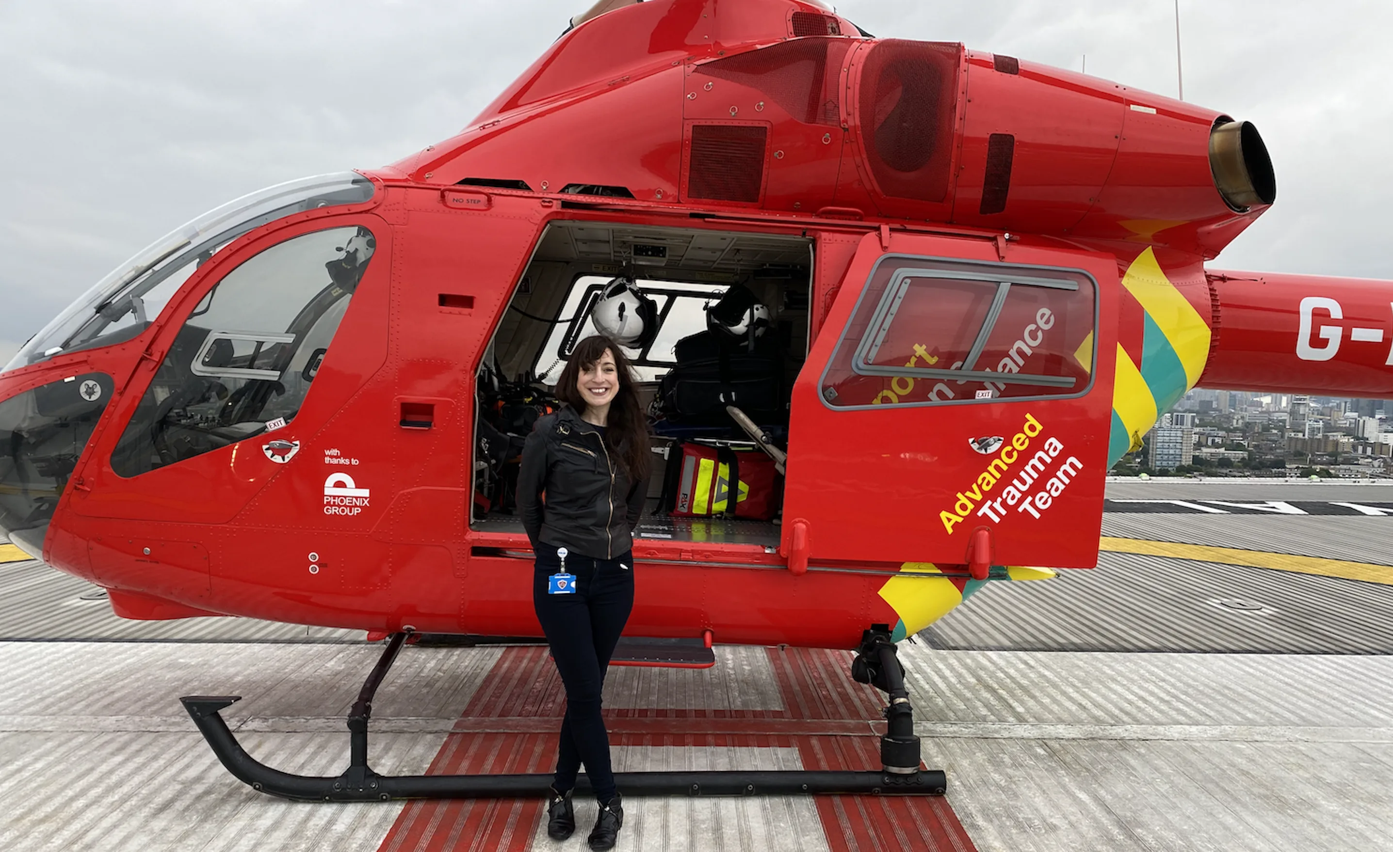 Dr Liz Harte in front of London's Air Ambulance Advanced Trauma Team helicopter