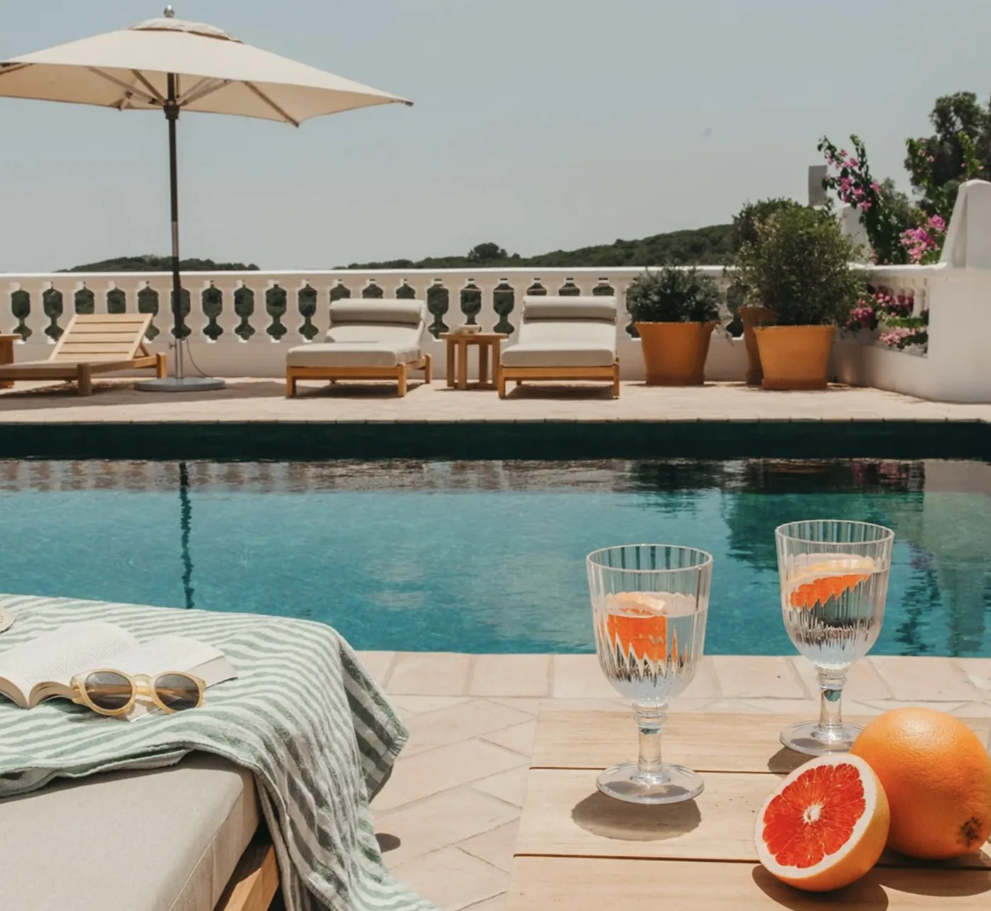 Poolside at the Menorca retreat villa, with loungers, books and drinks