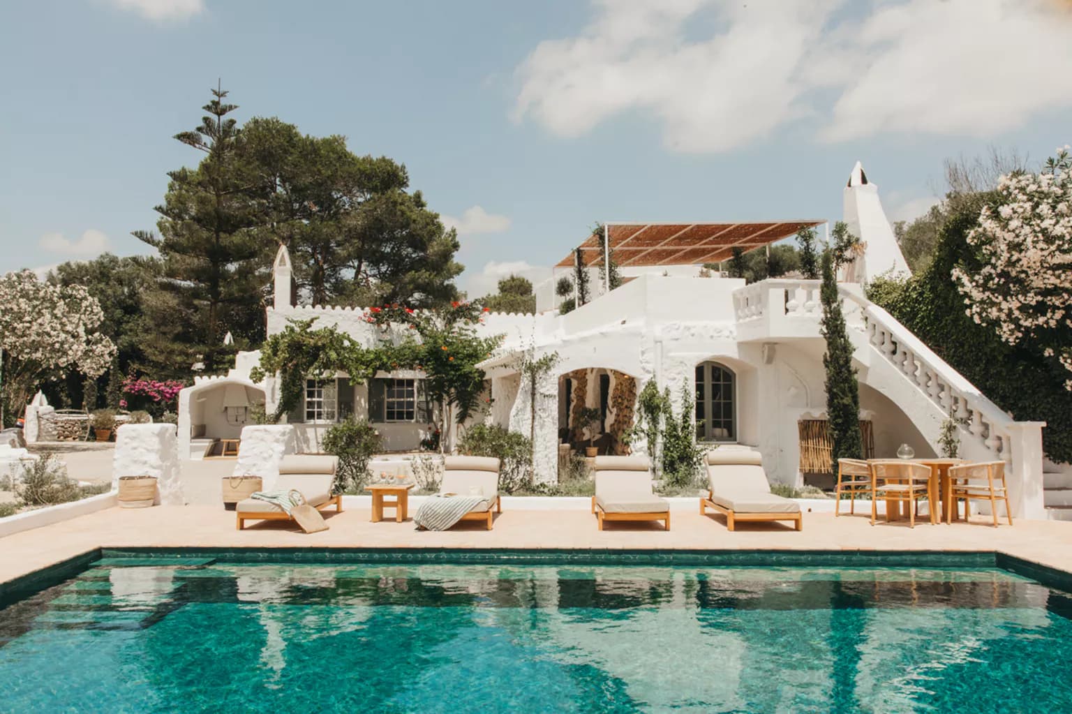 A whitewashed Menorcan villa with a pool and sun loungers